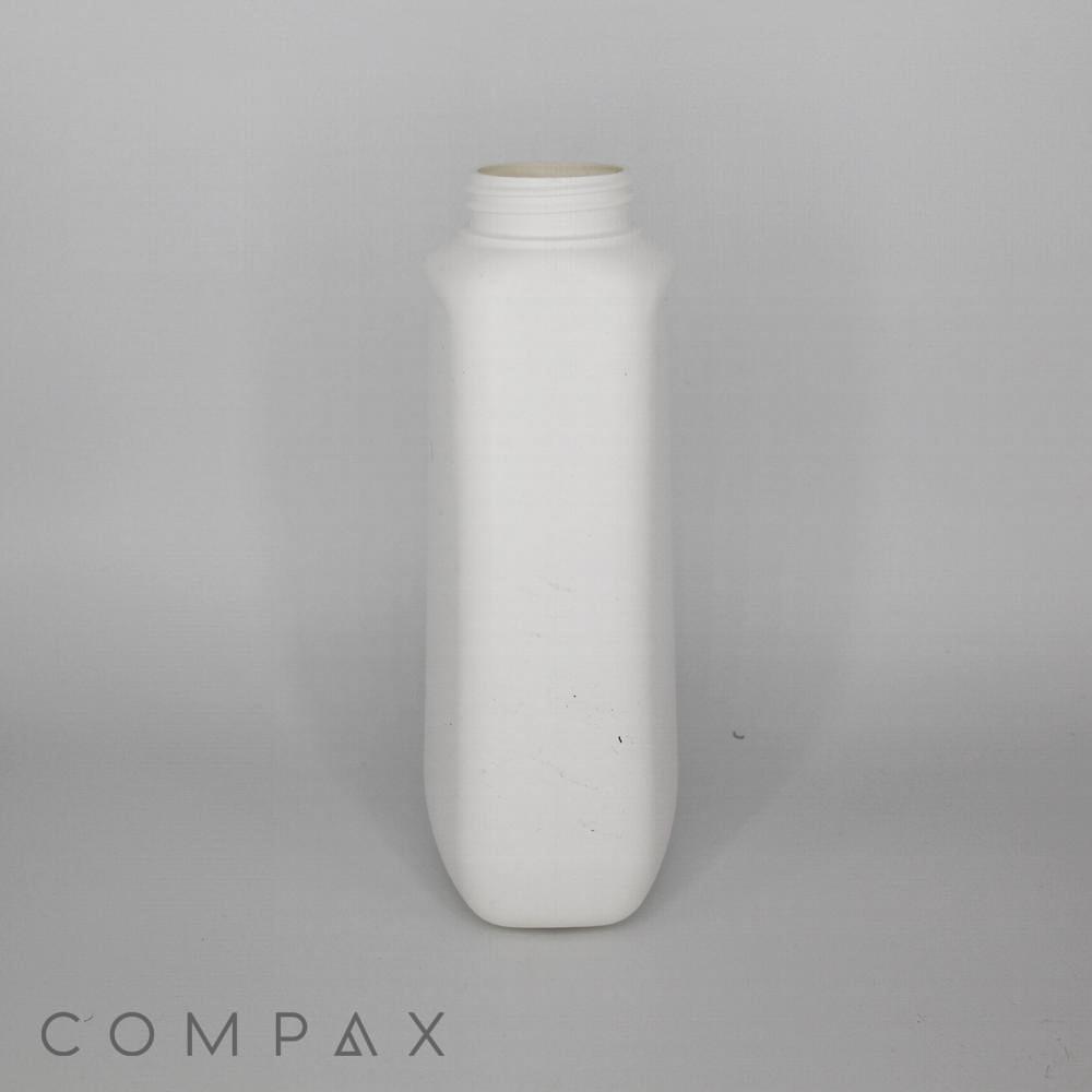 A plain white plastic bottle with a narrow neck and wide base is centered on a gray background. The brand name "COMPAX" is visible in the bottom left corner. The bottle is unmarked and lacks any labels or distinguishing features.