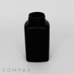 A black, rectangular plastic bottle with a screw-top opening is centered against a plain white background. The word "COMPAX" is visible in small letters near the bottom left corner of the image.