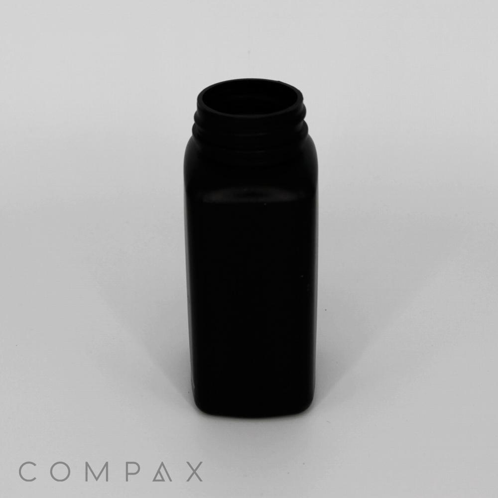 A matte black, rectangular plastic bottle with a threaded neck and open top is centered against a plain white background. At the bottom left corner, the word "COMPAX" is written in a minimalist font.