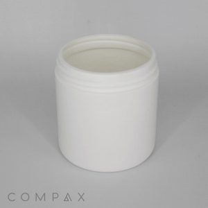 A small, empty, white plastic container with an open top is placed against a plain, light gray background. The container has a wide mouth and no visible label. The brand name "COMPAX" is faintly visible in the bottom left corner against the background.