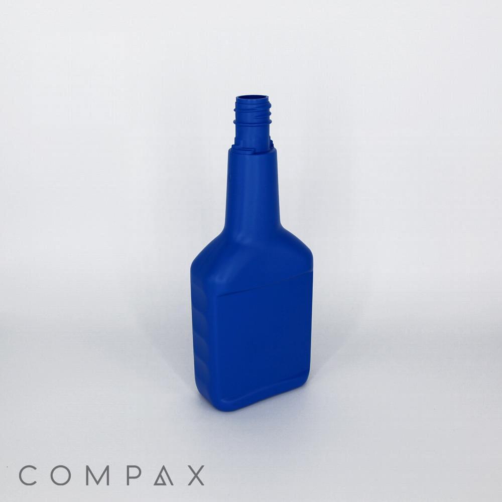 A blue, empty, rectangular plastic bottle with a narrow neck and ridged grips, standing upright on a plain white background. The word "COMPAX" is faintly visible in the bottom left corner.