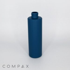 A tall, cylindrical, blue plastic bottle with a screw-top opening is centered against a plain white background. The brand name "COMPAX" is visible in the bottom left corner.