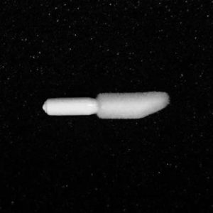 A single white Nylon Flocking Applicator with a tapered, cylindrical tip on one end and a narrow, stick-like handle on the other side, placed against a black background.