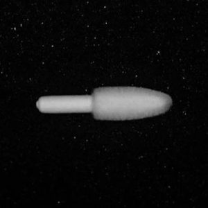 The Nylon Flocking Applicator, with its bullet-shaped design and elongated handle, is centered on a backdrop of numerous white specks that resemble stars scattered across a black background.
