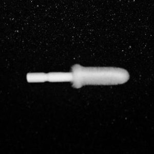 A blurry grayscale image of a small Nylon Flocking Applicator set against a dark, speckled background. The details of the applicator are indistinguishable due to the lack of focus.