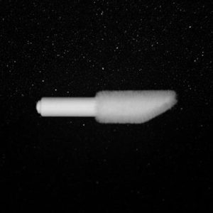 A Nylon Flocking Applicator with a capped lid is suspended in the center of a speckled black background, giving the impression that it is floating in a starry space. The applicator is partially blurred, creating a sense of motion.