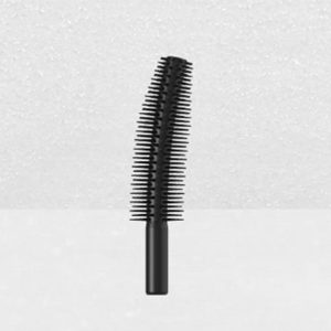 Close-up image of a black, curved Plastic Brush Applicator against a plain, light gray background. The applicator has fine bristles evenly spaced along its length, designed for separating and coating eyelashes.