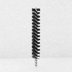 A Nylon Brush Applicator with tightly packed black bristles and a twisted metal handle is positioned upright against a speckled white background. The bristles are arranged in a spiral pattern around the central metal wire.