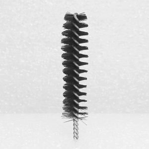 A Nylon Brush Applicator, featuring a black cylindrical head with bristles wound around a central twisted wire stem, is displayed against a plain white background. The brush has a slightly tapered end and is ideal for cleaning narrow tubes or confined spaces.