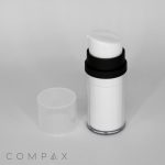 A white cylindrical Double Wall Airless Pump Bottle with a black band near the top stands beside a clear plastic cap on a plain white background. The bottle appears to be a cosmetic or skincare product. The word "COMPAX" is visible in the bottom left corner.