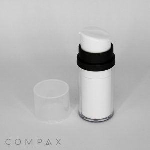 A white cylindrical Double Wall Airless Pump Bottle with a black band near the top stands beside a clear plastic cap on a plain white background. The bottle appears to be a cosmetic or skincare product. The word "COMPAX" is visible in the bottom left corner.