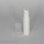 A white cylindrical pump bottle with a clear cap removed, placed beside it. The bottle has a sleek design and is set against a plain light grey background. The word "COMPAX" is printed in grey at the bottom left corner of the image.