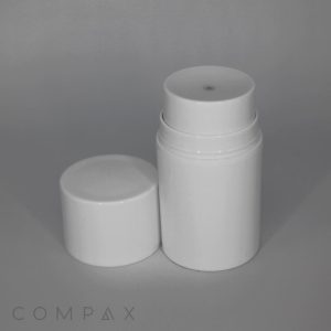 A smooth and clean white cylindrical PP Airless Pump Bottle with a removable cap, positioned to the left, revealing the product inside. The faintly visible brand name "COMPAX" is located in the bottom-left corner against a neutral background.
