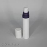 A Mini PP Airless Pump Bottle with Pure Pump Spring, featuring a white cylindrical body and a black top, is standing upright. The white cap is placed next to the bottle on a gray surface. The word "COMPAX" is faintly visible in the bottom left corner of the image.