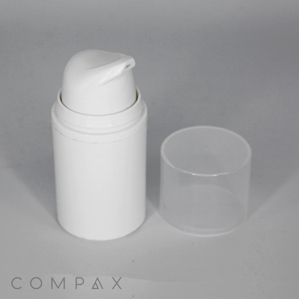 A PP Round Airless Pump Bottle with an open nozzle is placed alongside a clear, cylindrical cap. The background features a plain, light gray surface. The word "COMPAX" is printed in faint, gray letters on the lower-left corner of the image.