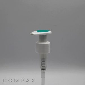 A white, cylindrical pump dispenser featuring a silicone top in light green, likely designed for a bottle. The image has a plain gray background with the word "COMPAX" in the bottom left corner. The dispenser includes a long, transparent tube attached to it.