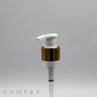 A white plastic pump with a shiny gold collar and a clear tube underneath is displayed against a plain, light gray background. The brand name "COMPAX" is visible at the bottom left corner.