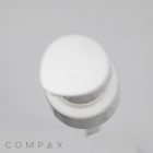 Image of a white "Sleek Pump" dispenser with a round top, typically found on bottles of liquid soap, lotion, or sanitizer. The pump is pressed down slightly, indicating usage. The word "COMPAX" is visible at the bottom of the image.