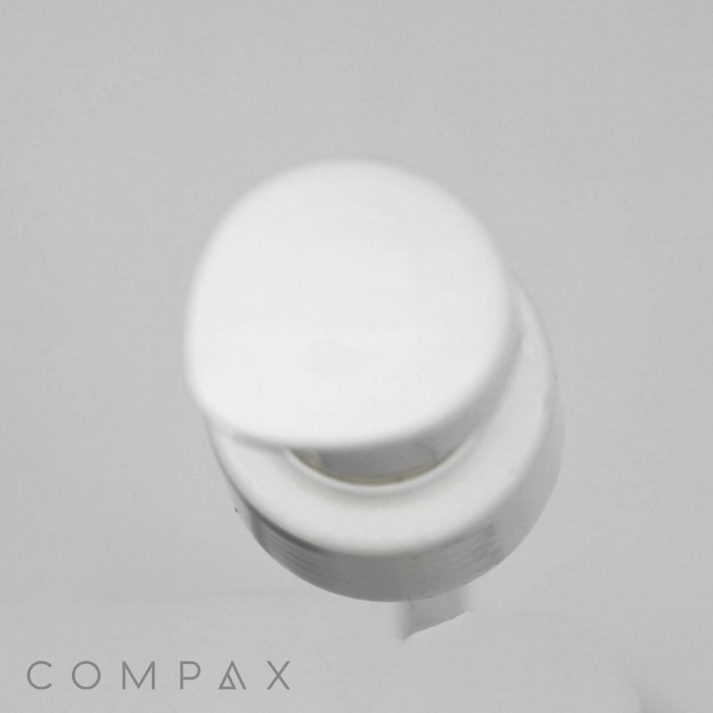 Image of a white "Sleek Pump" dispenser with a round top, typically found on bottles of liquid soap, lotion, or sanitizer. The pump is pressed down slightly, indicating usage. The word "COMPAX" is visible at the bottom of the image.