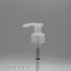 Clear plastic Pump dispenser with a cylindrical base and a slightly curved nozzle, displayed against a plain grey background. The word "COMPAX" appears in the bottom left corner.