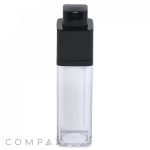 A clear, square bottle with a black pump dispenser at the top. The bottle is empty, and the transparent lower part contrasts with the opaque black top. The word "COMPAX" is partially visible in the bottom left corner of the image.