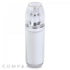 A clear, cylindrical Double Wall Airless Bottle with a silver pump and a matching clear cap stands upright. The bottle features a white inner container, and the word "COMPAX" is visible in the lower-left corner of the image.