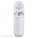 A clear, cylindrical Double Wall Airless Bottle with a silver pump and a matching clear cap stands upright. The bottle features a white inner container, and the word "COMPAX" is visible in the lower-left corner of the image.