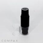 A black cylindrical Dual Stick + Blender cosmetic tube stands upright with the cap removed and placed beside it on a white background. The logo "COMPAX" is visible at the bottom left corner of the image.