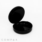 A black, Single Well Round Compact with Mirror features a hinged lid that opens to reveal an empty interior. The compact is set against a white background, with the brand name "COMPAX" displayed in gray text at the bottom left corner of the image.