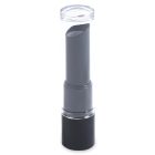 A Round Lipstick in black is enclosed in a clear cylindrical tube on a white background. The brand name "COMPAX" is displayed in grey letters at the bottom left of the image.