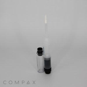 A transparent plastic container named the Round Dual Lip or Eye Bottle, featuring a slim, clear cap and a white applicator brush. The container has black cylindrical components at the bottom, with the brand name "COMPAX" visible at the bottom left of the image.