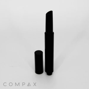 A stylish, black Round Click Up Pen with an angled tip is standing upright against a white background. The cap is placed beside it. The word "COMPAX" is printed in light gray text at the bottom left corner.