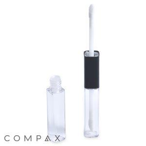 A clear Square Dual Lip + Eye Bottle stands open with its wand applicator leaned against it. The wand has a white sponge tip and a black cap. The background is solid white, and the word "COMPAX" is visible in the bottom left corner.