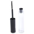 A clear empty Round Mascara Bottle and a black mascara brush with its wand are placed side by side. The brand name "COMPAX" is printed at the bottom of the image. The black brush handle stands vertically inside the open tube cap.