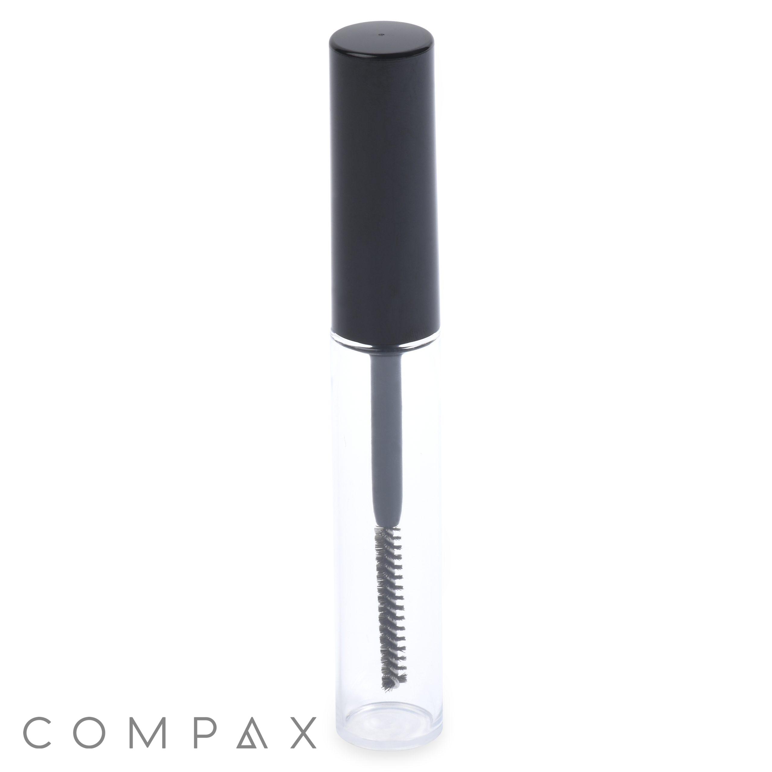 A clear, cylindrical container with a black cap houses a small brush applicator inside. This cosmetic product is identified as the "Round Mascara Bottle." The word "COMPAX" is visible at the bottom left corner of the image.