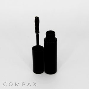 A Mini Round Mascara Bottle with a brush wand is displayed on a white background. The tube is open, revealing the brush with product on it. The brand name "Compax" is visible in the lower left corner.