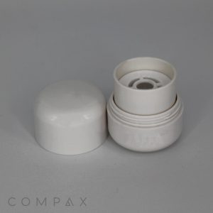A Round Beauty Stick, featuring a white, two-piece plastic design, is displayed against a neutral background. The container is disassembled with the top piece lying on its side next to the upright base. The word "COMPAX" is faintly visible at the bottom.