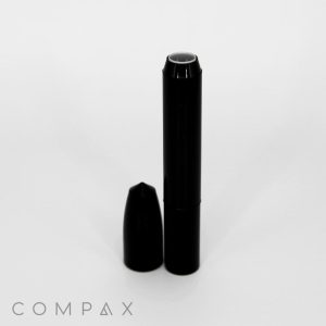A black Round Beauty Pencil with a detachable cap placed beside it. The product has a sleek design with "COMPAX" written in light grey at the bottom left corner, all set against a plain white background.
