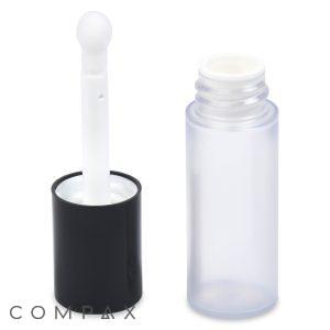 A Mini Round Cosmetic Bottle with Applicator is displayed. The clear, small cylindrical container has a black cap, which is open to reveal a white applicator wand with a round tip. The container stands upright beside the detached cap and is empty. The word "COMPAX" appears in the bottom left corner of the image.