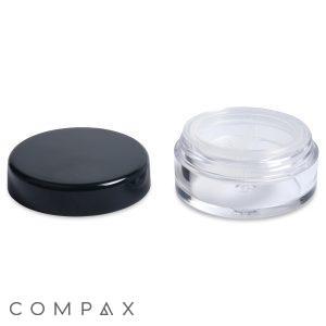 An 8ml Powder Sifter Jar is displayed with its removed black lid next to it. The lid is flat, round, and the transparent cylindrical container has an open top and a clear base. The word "COMPAX" is printed at the bottom left corner.