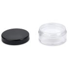 A 20ml Powder Sifter Jar with a clear, empty round body and a removable black lid placed beside it. The jar is transparent, while the lid is opaque. The composition is minimalistic against a white background, with the word "COMPAX" printed at the bottom left corner.