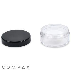 A 20ml Powder Sifter Jar with a clear, empty round body and a removable black lid placed beside it. The jar is transparent, while the lid is opaque. The composition is minimalistic against a white background, with the word "COMPAX" printed at the bottom left corner.