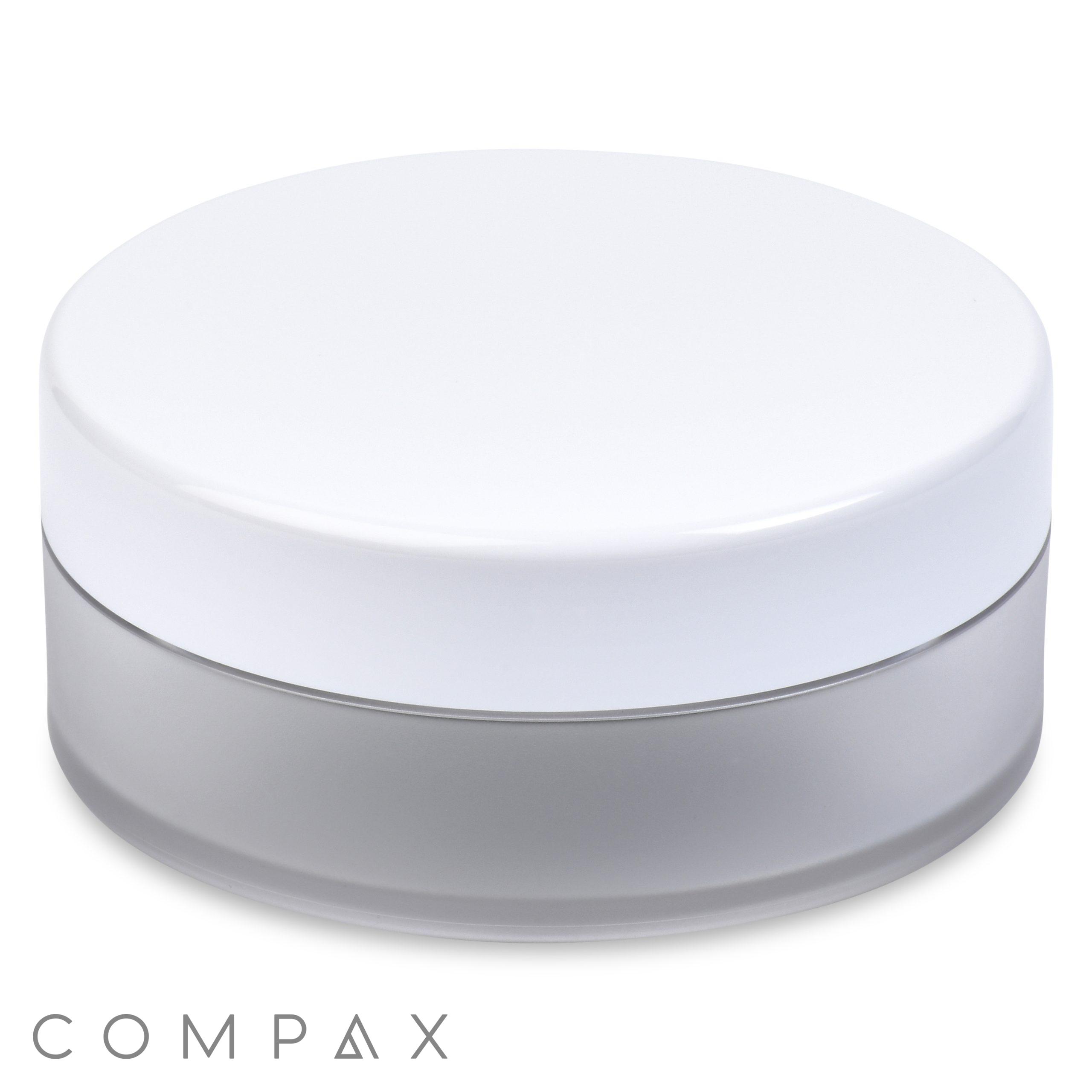 A round, translucent frosted 35ml Powder Sifter Jar with a white lid is centered against a white background. The base of the jar appears semi-transparent with a matte finish. The brand name "COMPAX" is printed in simple gray letters below the jar.