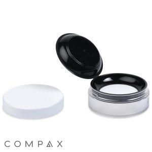An open 35ml Powder Sifter Jar with a black lid reveals a white makeup sponge inside. Next to it lies a separate, detached white lid. The brand name "COMPAX" is visible at the bottom left of the image.