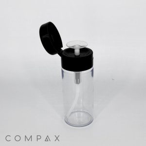 A 120mL Round PET Bottle with a transparent body and a black flip-top lid featuring an internal pump mechanism is displayed. The empty bottle is set against a plain white background, with the word "COMPAX" written at the bottom left corner.