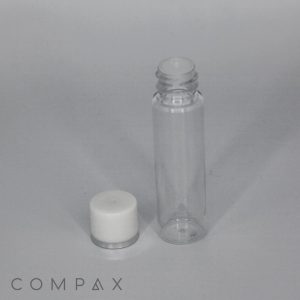 A clear, 15mL Round PET Bottle with a white, removable cap placed beside it. The cap has a silver base and the bottle is standing upright against a plain, light gray background. The word "COMPAX" is faintly visible in the bottom left corner.