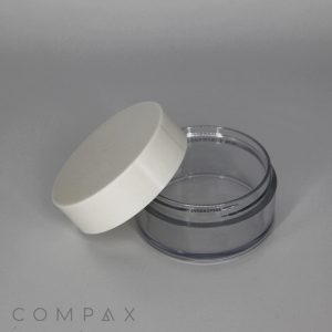 A 50mL PET Jar with a tall cap lies against a plain gray background. The transparent container reveals its empty interior, and the brand name "COMPAX" is visible in the bottom left corner.
