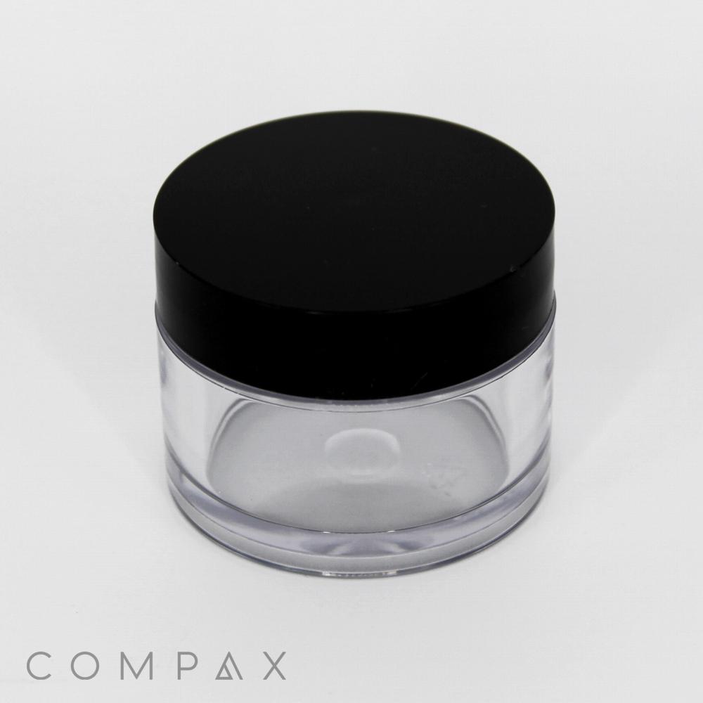 A 30mL PET Jar, with a small, round and clear plastic body featuring a black lid, displayed against a white background. The container appears to be empty, and the brand name "COMPAQ" is printed in light gray at the bottom left corner.