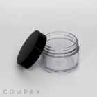 A small, clear, cylindrical 30mL PET Jar with a black screw-on lid, shown open. The background is white, and the image features the "COMPAX" logo in the bottom left corner. The jar appears empty and is made of plastic.