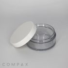 A clear, empty plastic container with a white short cap placed slightly ajar. The container is cylindrical and transparent, allowing the interior to be visible. The brand name "COMPAX" appears in lowercase letters at the bottom left corner of the image.
